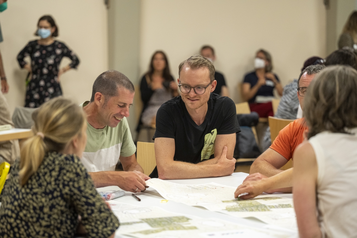 Menschen arbeiten mit Papieren an einem Tisch