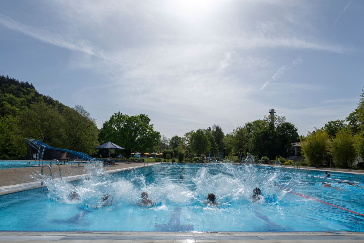 Freibecken im Freibad mit fünf Besucher*innen