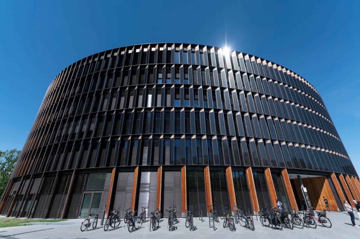 Eine Totale des Rathaus im Stühlinger bei Sonnenschein. Am unteren Bildrand stehen Fahrräder.