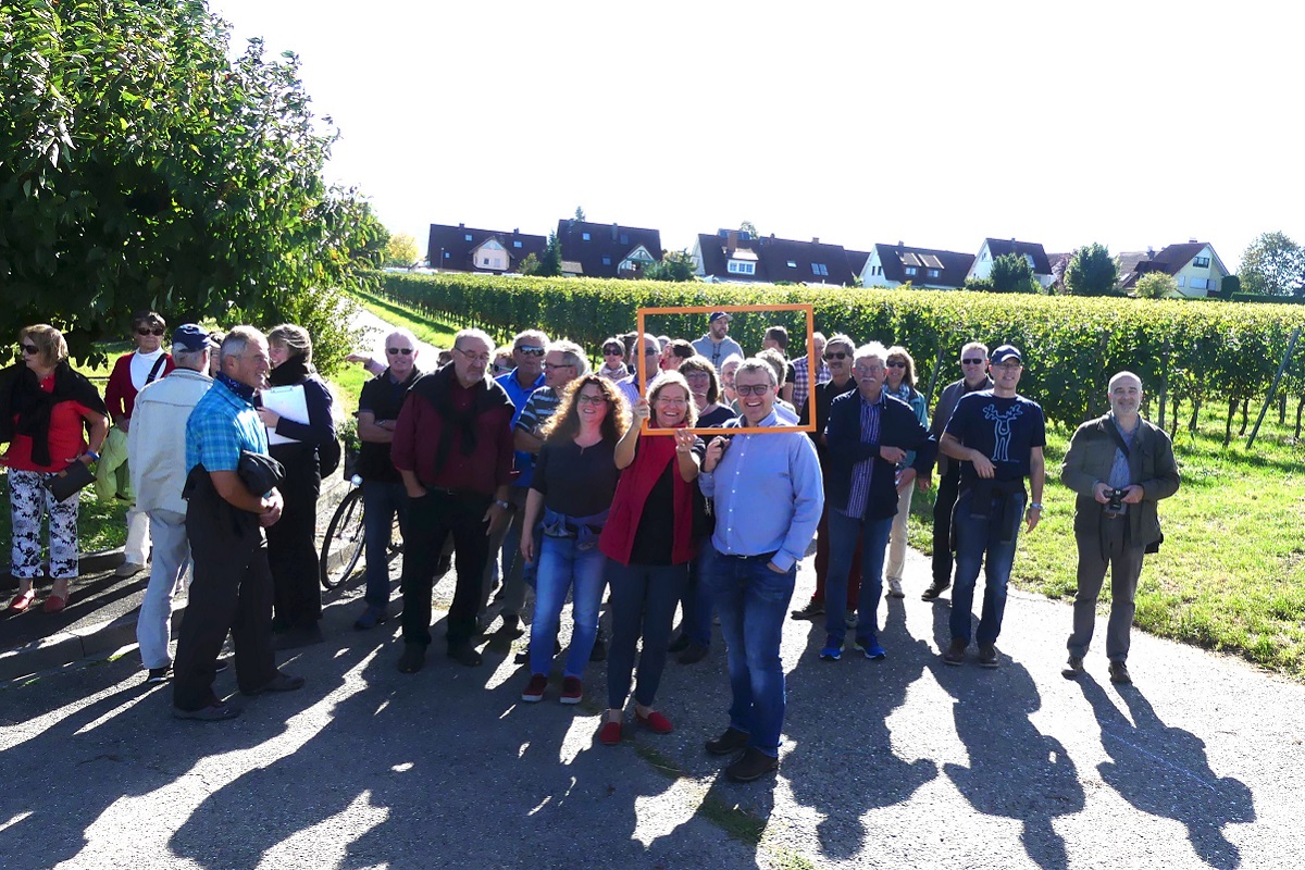 Rahmenplanung, Erkundung Opfingen Gruppenfoto vor Weinreben mit einer Ortschaft im Hintergrund